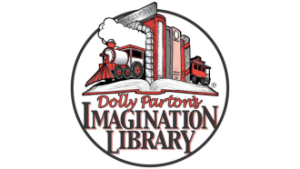 Row of books propped up by train bookends on an open book. Dolly Parton's Imagination Library