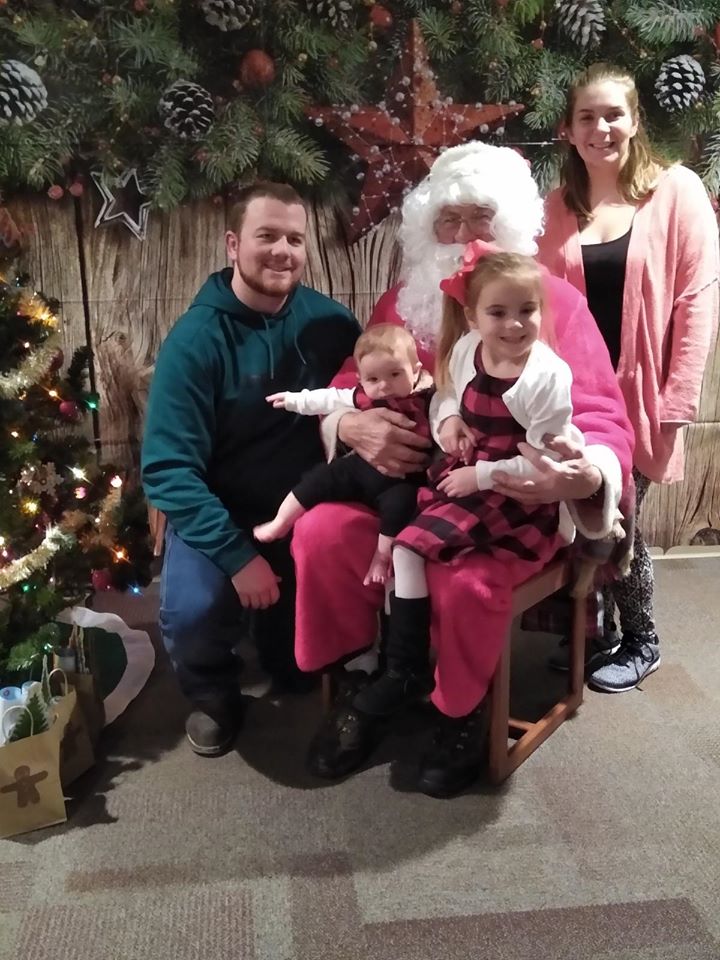Families visiting with Santa at the library